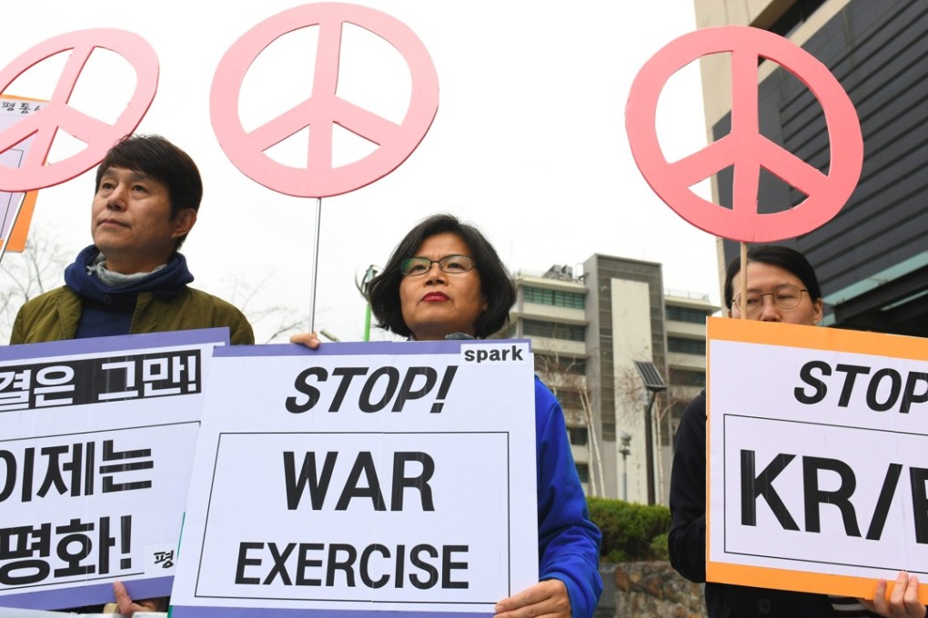 Anti-war activists hold signs during a rally denouncing the annual ‘Foal Eagle’ joint military drill near the US embassy in Seoul. Photo: AFP