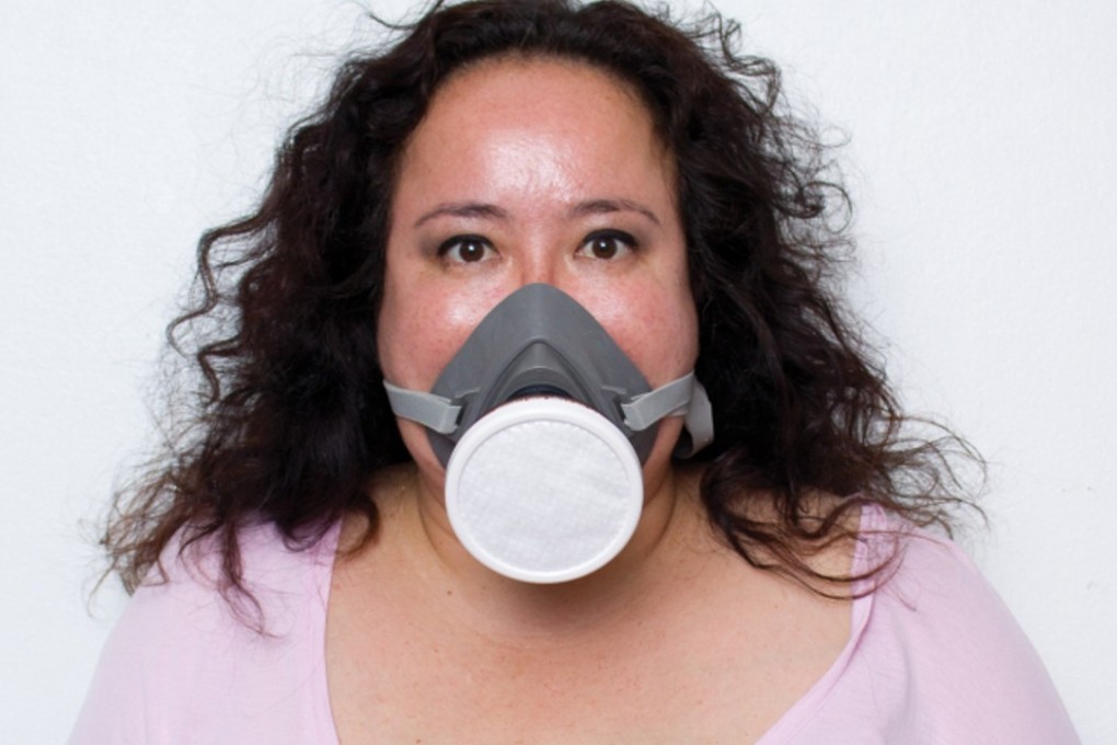 Pim Kemasingki, editor of the Chiang Mai Citylife magazine, wears a face mask in a photo that accompanied a recent editorial she wrote about pollution. She faces possible criminal charges for sharing a student’s picture of historic kings wearing face masks. Photo: Chiang Mai Citylife