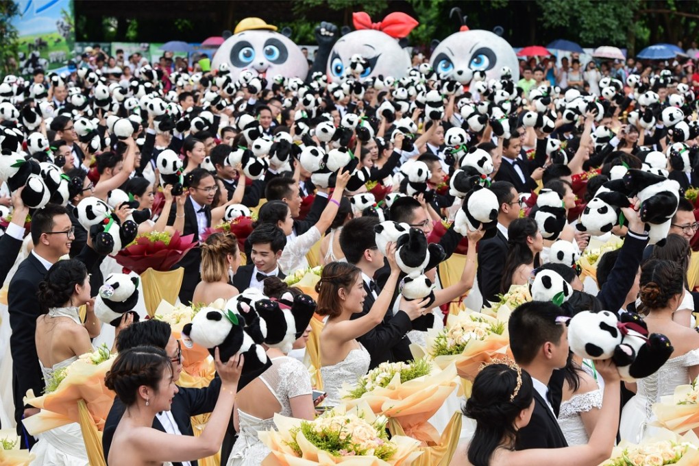Couples attend a group wedding ceremony at the Chimelong Safari Park in Guangzhou on July 8, 2017. The number of cross-border marriages between Hongkongers and people from the mainland is rising. Photo: Xinhua