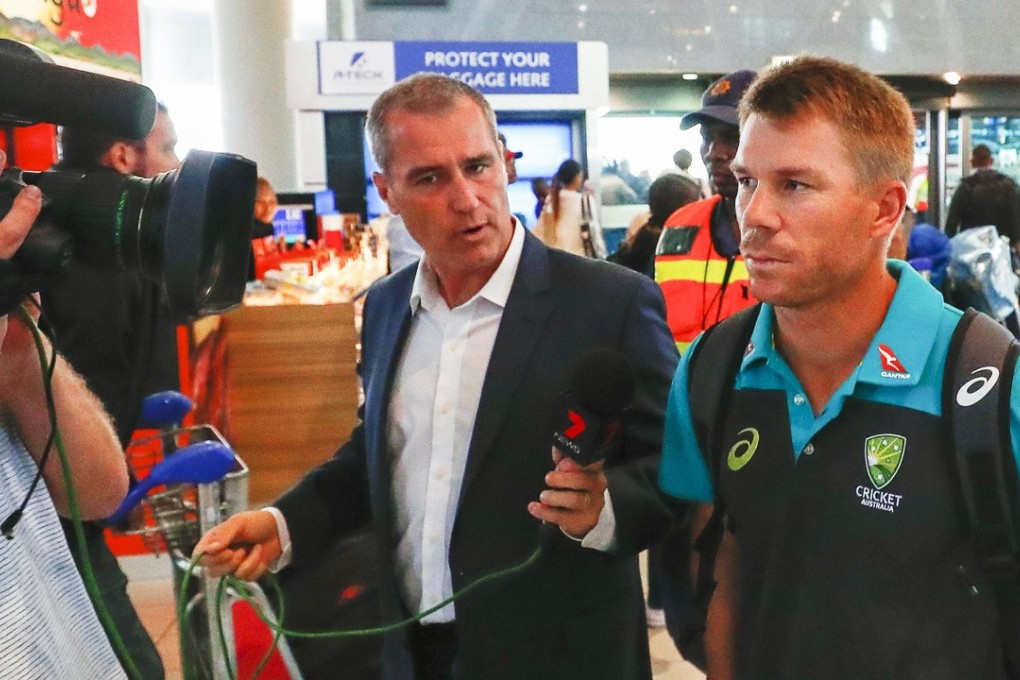 Australian cricket player David Warner (right) departs from Cape Town International airport after stepping down as vice captain. Photo: EPA