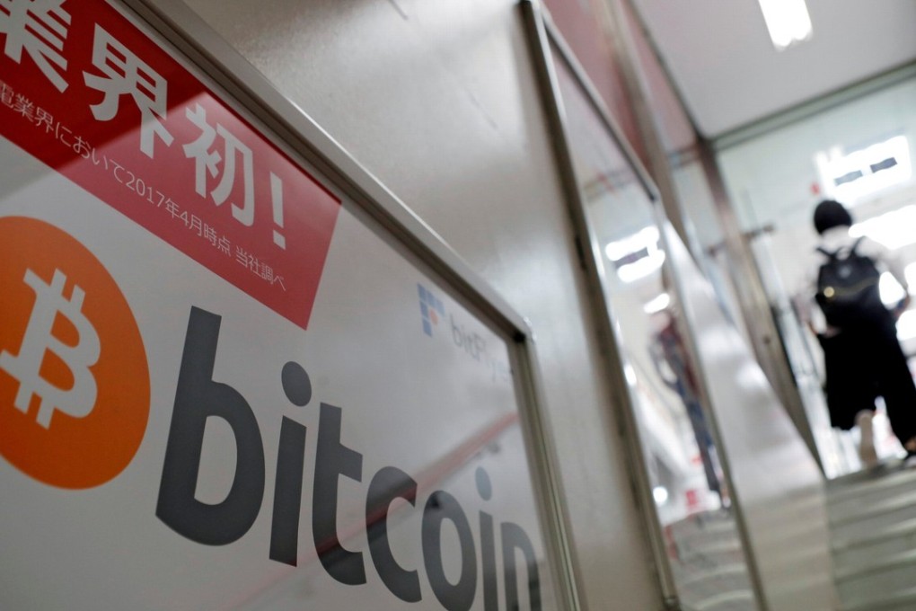 A bitcoin logo seen on an advertisement for an electronics shop in Tokyo. Photo: Reuters