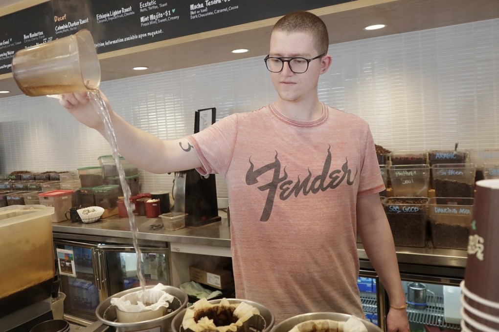 Adam Lange pours water while making coffee at a Philz Coffee shop in San Francisco on Friday. Coffee sellers will have to post ominous warnings in California because each cup contains a chemical linked to cancer, a judge ruled – but some say the link has been overstated. Photo: AP