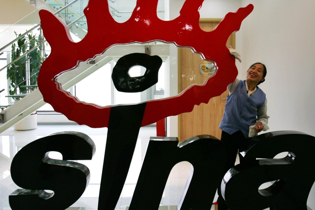 Sina was one of the firms given an undisclosed fine. A file picture shows a cleaner polishing a sign of the company logo at its Beijing headquarters. Photo: AP