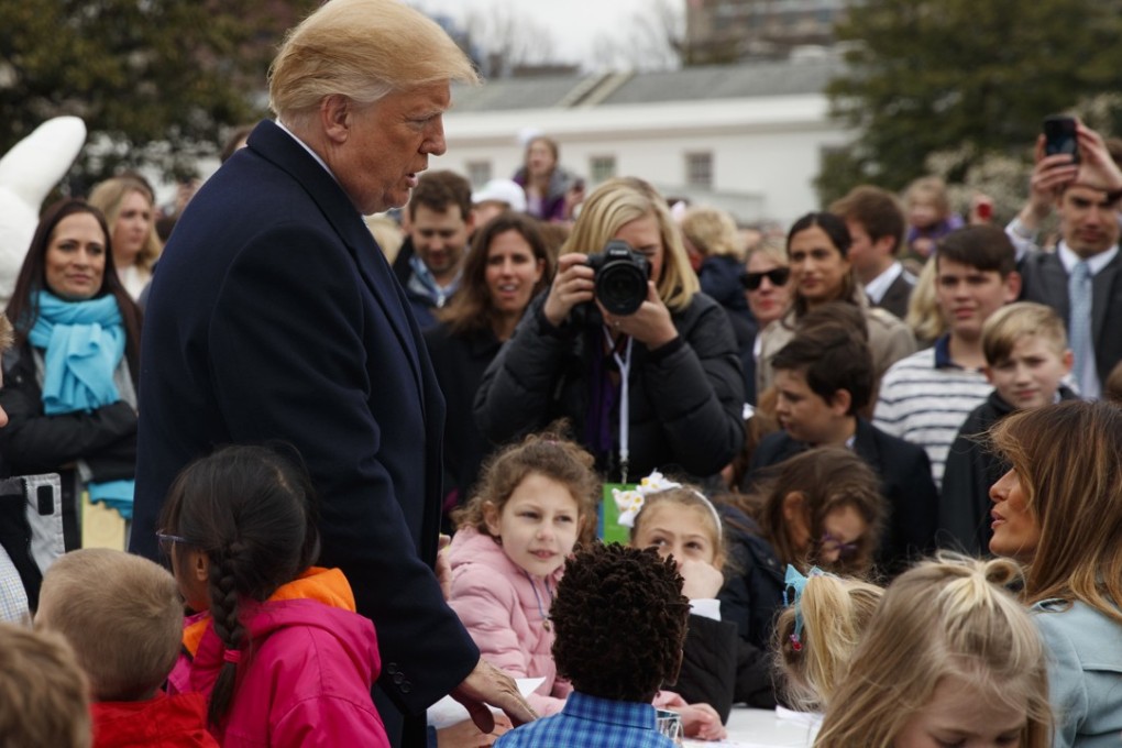 US President Donald Trump talks with first lady Melania Trump as she sits at a table with children writing cards for troops at the White House on Monday, during the annual White House Easter Egg Roll. Trump’s tweet against Amazon earlier in the day was the third time he had attacked the company since Thursday. Photo: AP