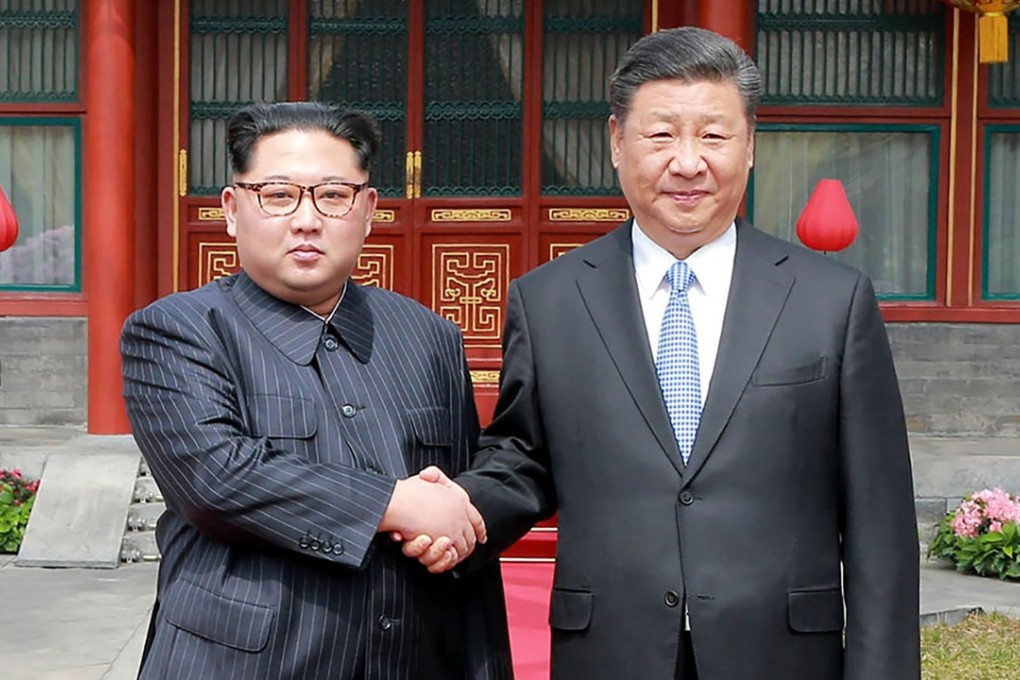 China's President Xi Jinping shakes hands with North Korean leader Kim Jong-un in Beijing on March 27. Photo: AFP