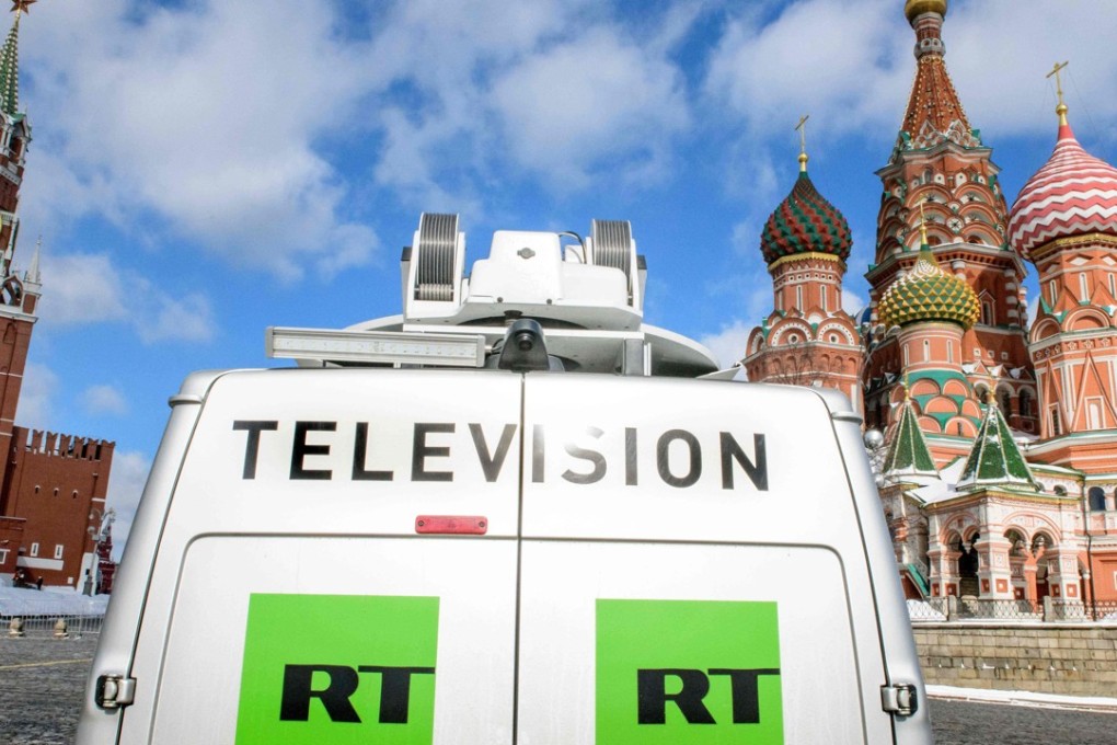 A Russia Today (RT) television broadcast van is seen parked in front of St Basil's Cathedral and the Kremlin next to Red Square in Moscow on March 16, 2018. The Russian-backed TV channel RT disappeared from broadcasts around Washington. The network vanished from cable channels on April 1, 2018, when the station that ran RT permanently closed. Photo: AFP