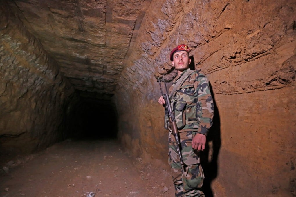 A Syrian government soldier stands inside a tunnel previously used by rebel fighters in Jobar in Eastern Ghouta on Tuesday. Photo: Agence France-Presse