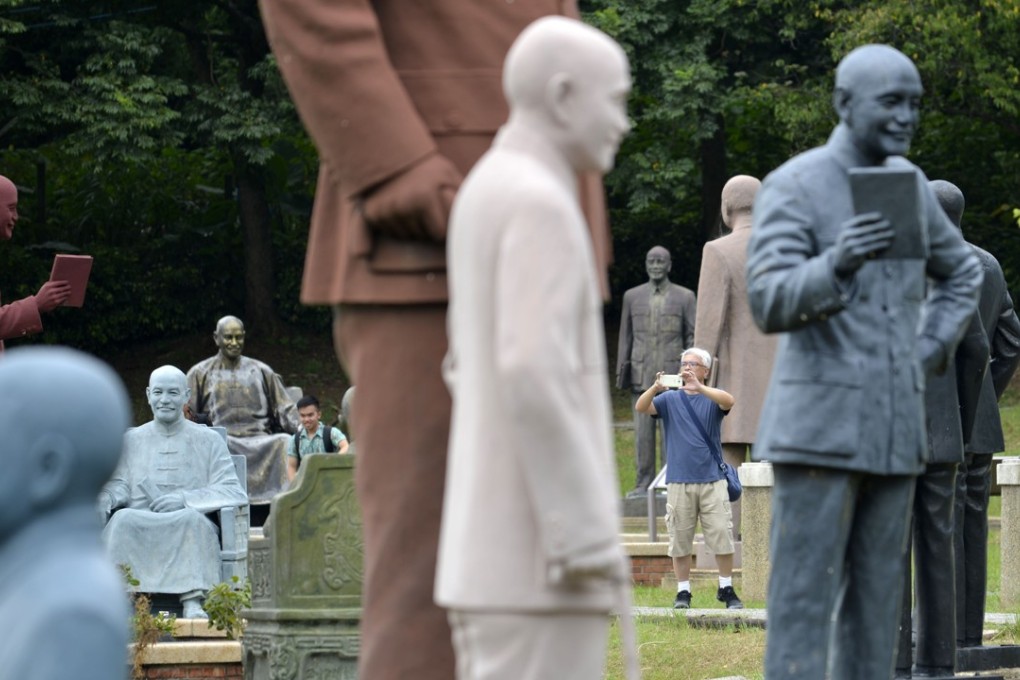 A man takes pictures at a park filled with statues of Chiang Kai-shek in Taiwan. Ten people have been charged with defacing the former leader’s tomb at his mausoleum in the northern city of Taoyuan. Photo: AFP