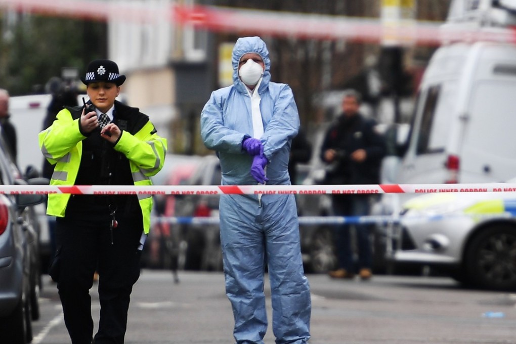 Police and forensic officers work at the scene of a gun crime in Tottenham, in the north of London. Photo: EPA