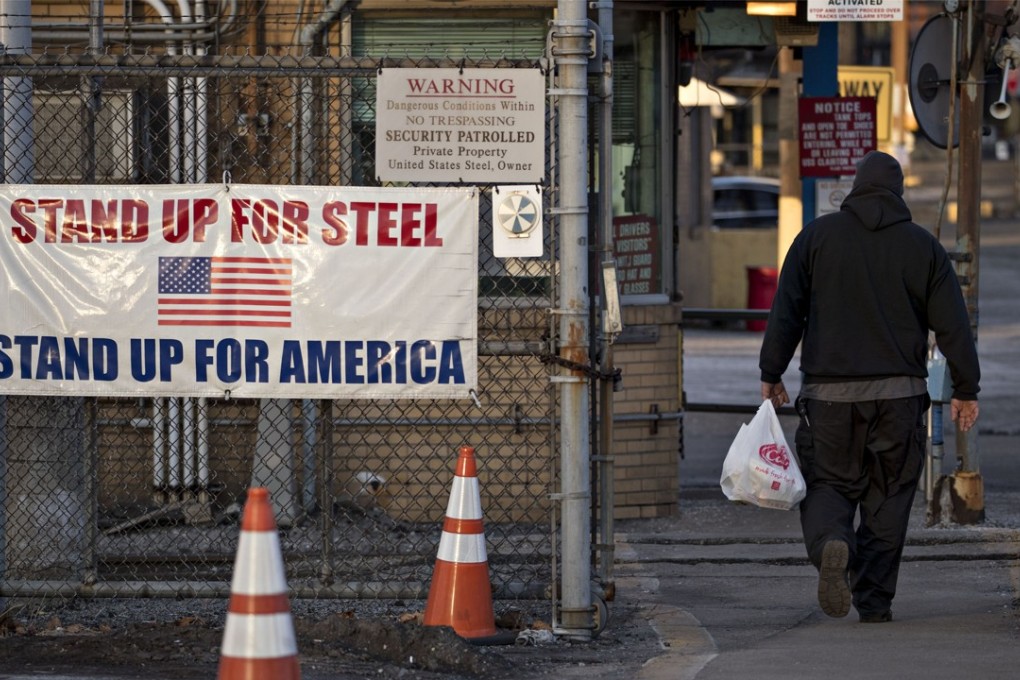 A man walks past a ‘Stand Up For Steel, Stand Up For America’ sign while arriving at the United States Steel Corporation Clairton Plant in Clairton, Pennsylvania, on March 11. US manufacturing has suffered after US President Donald Trump announced tariffs on foreign steel and aluminium, as prices shot up and companies panic-bought stocks. Photo: Bloomberg