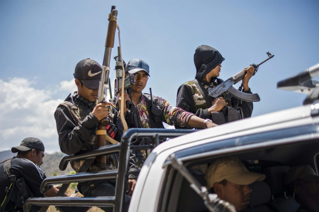 Guerrero Community Police members patrol the hills in Carrizalillo, Guerrero state, Mexico, on March 24. The state has been wracked with violence from drug traffickers, including a murder spree that has seen nine political candidates murdered in recent weeks. Photo: AFP