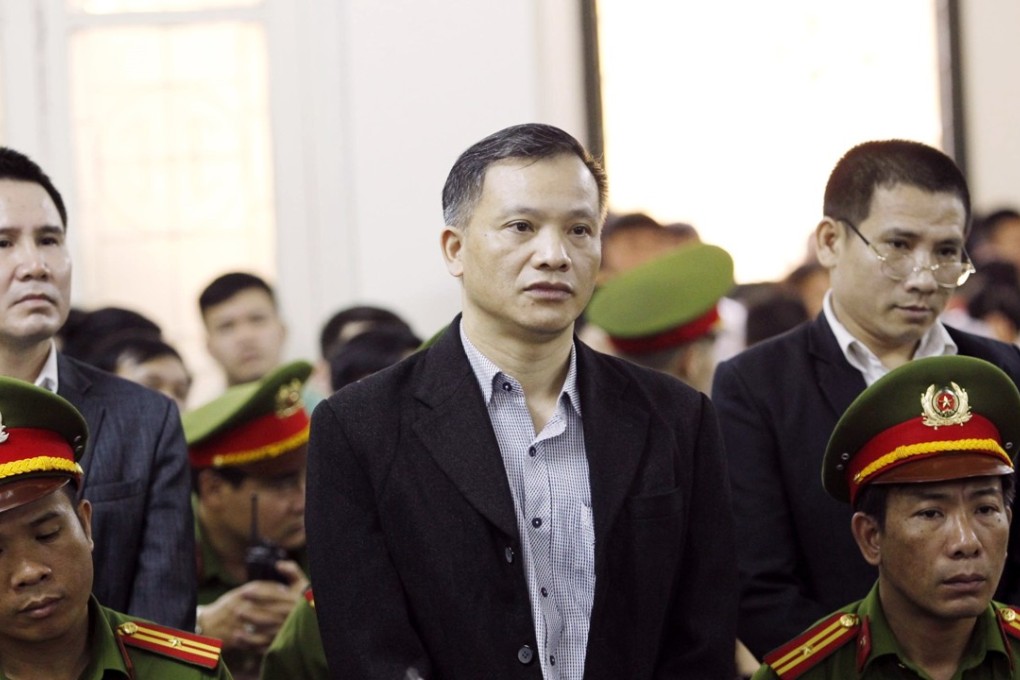 Prominent human rights lawyer Nguyen Van Dai, centre, stands trial in Hanoi. Photo: AP