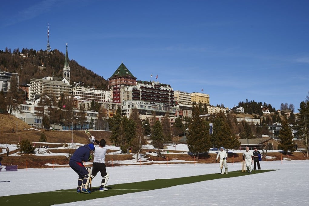 A cricket match in progress on frozen Lake St Moritz, with Badrutt’s Palace Hotel in the background. Picture: AFP