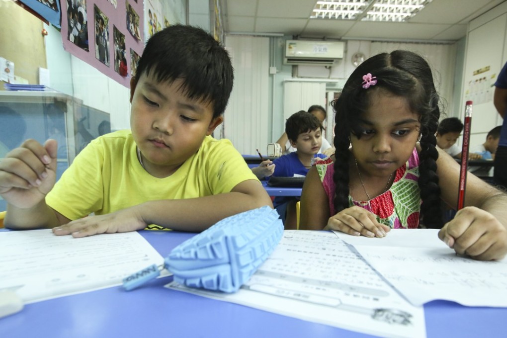 Ethnic minority pupils work on their homework at the Integrated Brilliant Education Centre in Jordan, which provides after-school help to non-Chinese-speaking children. Photo: Edmond So