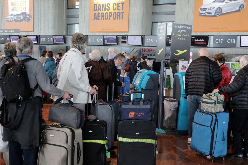 Passengers wait at the Air France check in at Nice airport as Air France pilots, cabin and ground crews unions call for a one-day strike over salaries in France on March 30. A second strike will ground planes across the country on Saturday. Photo: Reuters