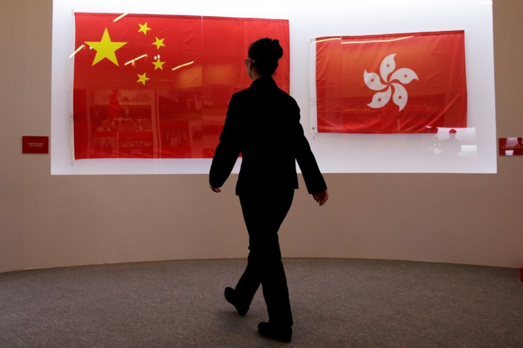 The flags of China (left) and Hong Kong used during the 1997 handover ceremony being displayed at an exhibition to celebrate the 20th anniversary of the city’s return to Chinese rule, Photo: Reuters