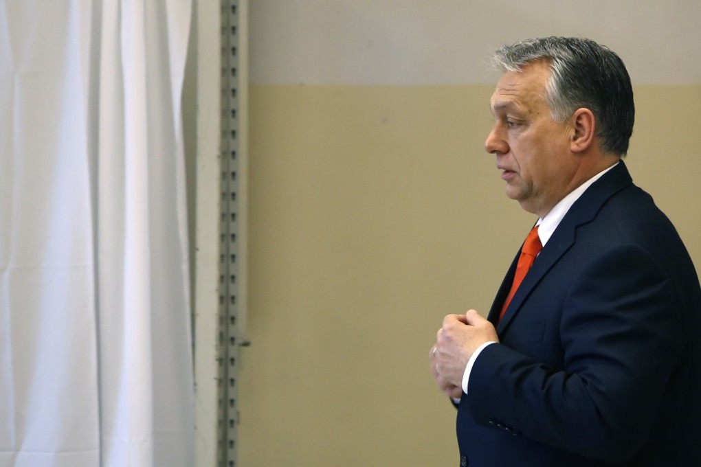 Hungary's prime minister Viktor Orban walks in a polling station in Budapest, Hungary, Sunday, April 8, 2018. Orban is expected to win his third consecutive term, and fourth overall since 1998, as voting stations opened across the country for the election of 199 parliamentary deputies. (AP Photo/Darko Vojinovic)