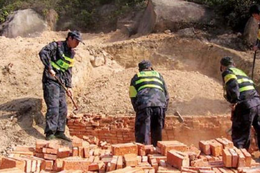 Workers knocking down a tomb in Tongcheng county. Photo: Aihami.com