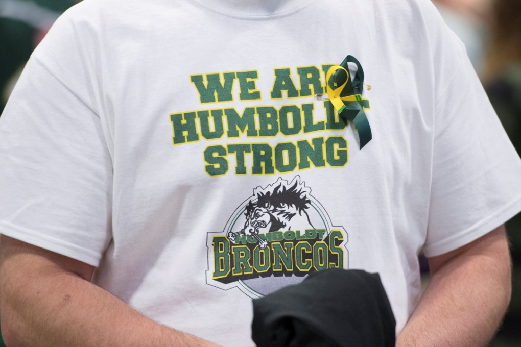 A man wears a Humboldt Broncos shirt during a vigil at the Elgar Petersen Arena, home of the Humboldt Broncos, to honour the victims of the fatal bus accident in Humboldt, Saskatchewan, Canada April 8, 2018. Jonathan Hayward/Pool via REUTERS