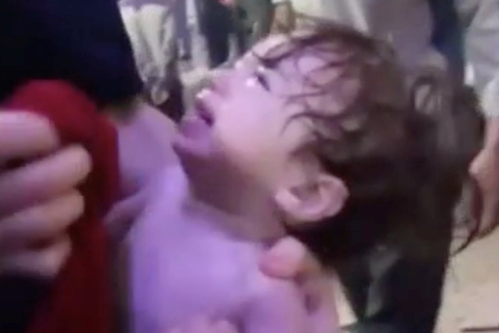 A child cries as he has his face wiped following a chemical weapons attack in Syria. Photo: Reuters