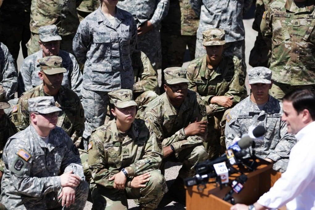 Members of the Arizona National Guard listen to Arizona Governor Doug Ducey on Monday at the Papago Park Military Reservation in Phoenix. Photo: AFP