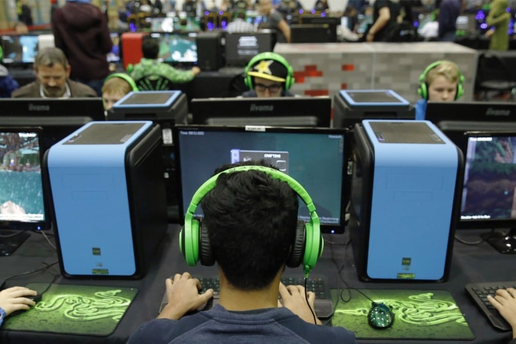Visitors wearing headphones play Minecraft Parkour. Photo: Bloomberg