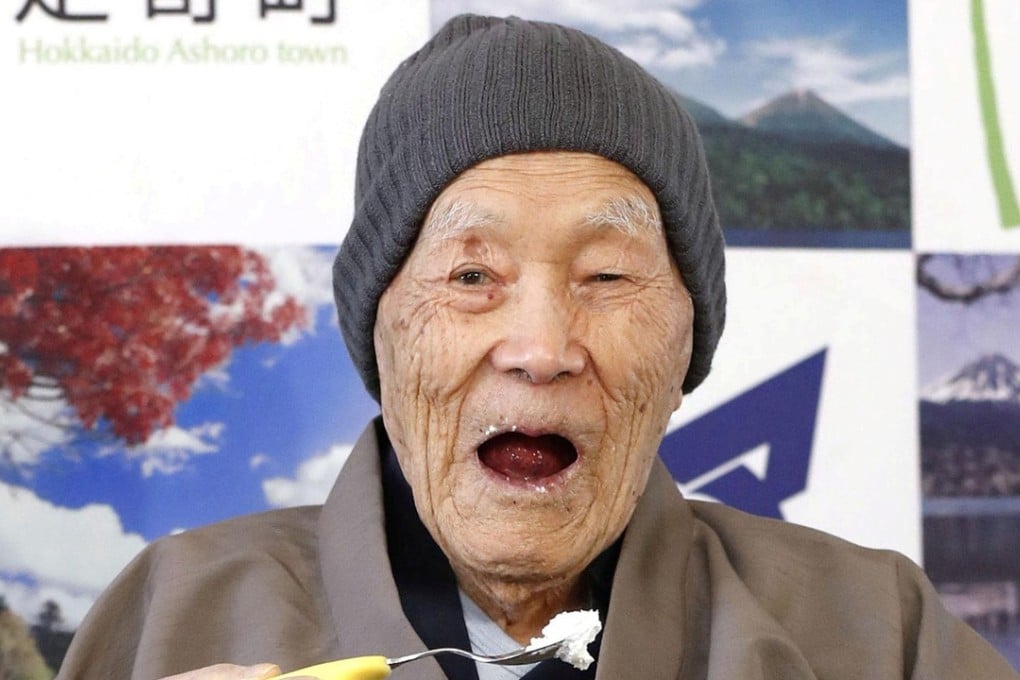 Japanese Masazo Nonaka, who was born 112 years and 259 days ago, eats his favourite cake. Photo: Kyodo