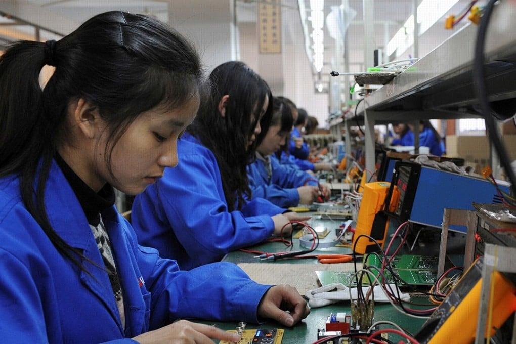 Workers assemble remote controls for air conditioners at a factory in eastern China. Photo: Reuters