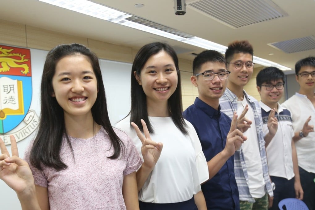 Top achievers in the 2017 Hong Kong DSE are all smiles in front of the crest of the University of Hong Kong, their new alma mater, as they meet the media at the HKU campus, on August 7 last year. Photo: David Wong