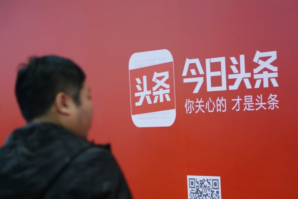 A man walks past an advertisement of Bytedance's news feed platform Toutiao, in Beijing.