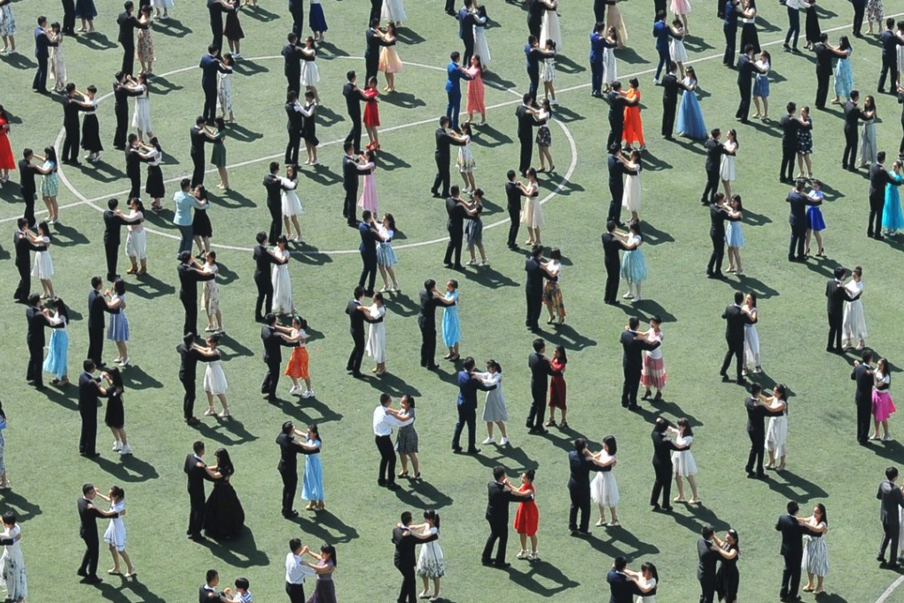 High school graduates in Lanzhou dance the waltz at their sports ground, in Gansu province in June 2016. The school held the ceremony ahead of the national college admission exams, which set the tone for the future of most young adults in China. Photo: China News Service