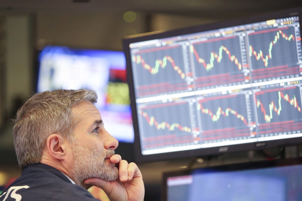 A trader ponders screens at the New York Stock Exchange on March 22, a day when the Dow Jones Industrial Average dropped more than 700 points following President Donald Trump’s announcement to impose tariffs on products imported from China. Photo: Xinhua
