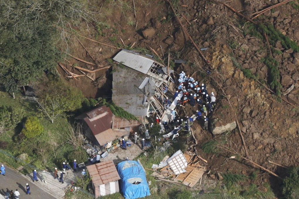 The aftermath of the landslide that hit homes. Photo: Kyodo