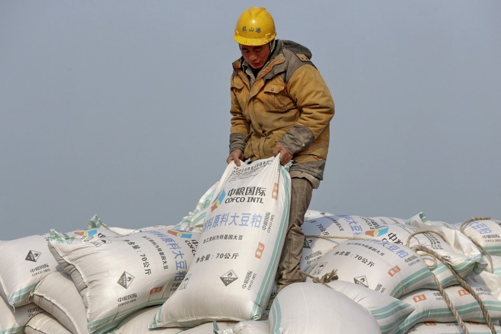 A worker arranges imported soybeans at a port in Nantong in east China’s Jiangsu province. The China International Import Expo will be a chance for overseas suppliers to promote their products to mainland buyers. Photo: AP