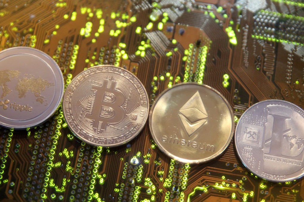 Representations of (left to right) the Ripple, Bitcoin, Etherum and Litecoin virtual currencies are seen on a PC motherboard. Photo: Reuters