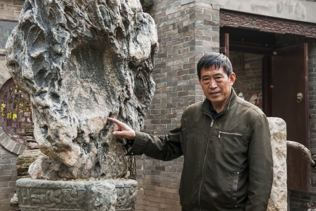 Former Red Guard Wu Jianguo with an old decorative stone, part of his collection of Chinese antiques and historical objects in rural Shaanxi province. Photo: Mark Andrews
