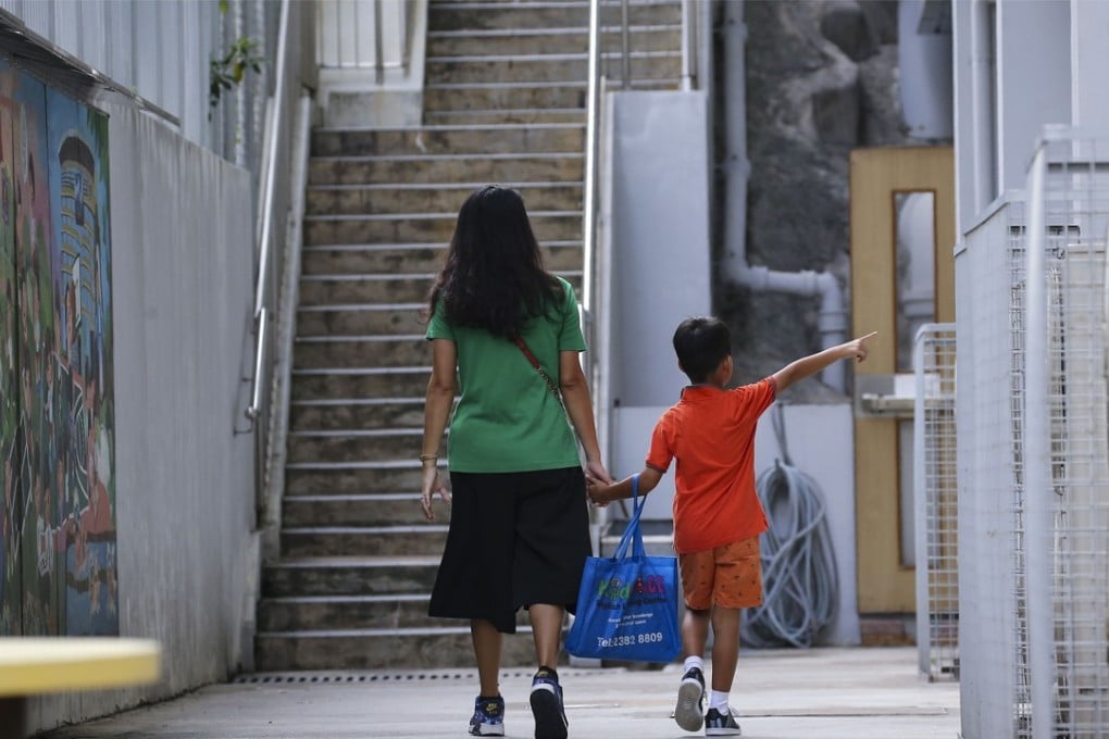 A mother and her son walk away after putting in an application for a Primary One discretionary place at an elite primary school in Kowloon City. Photo: Dickson Lee