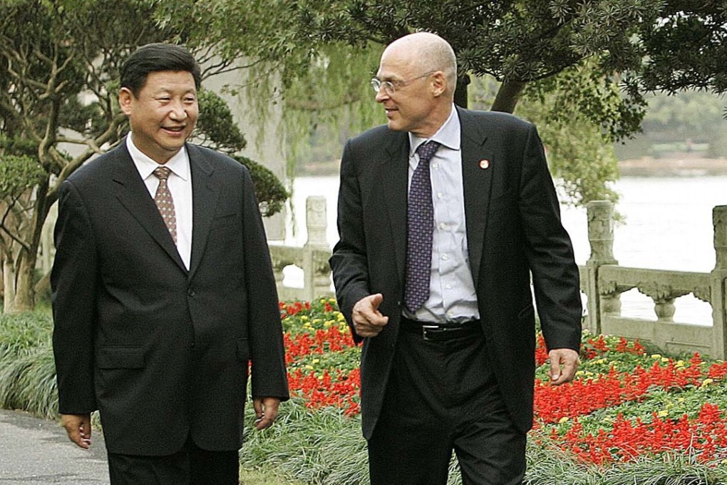 Former US treasury secretary Henry Paulson (right) and Xi Jinping stroll after a 2006 meeting in Hangzhou. Photo: AP