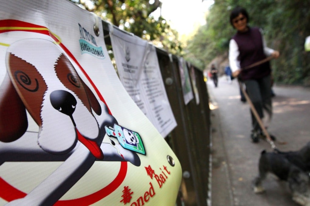 A poster warning dog owners to protect their pets from poisoned baits at Bowen Drive. Photo: Felix Wong