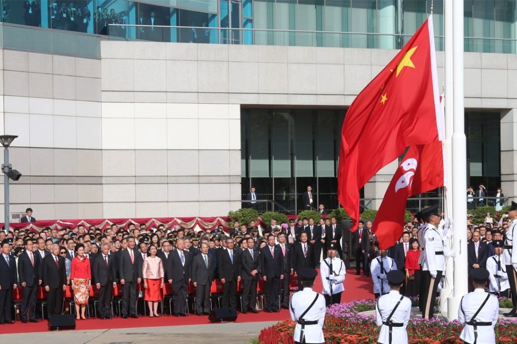 Officials attend a flag-raising ceremony at Golden Bauhinia Square, in Wan Chai, Hong Kong, on July 1, 2017. Photo: K.Y. Cheng