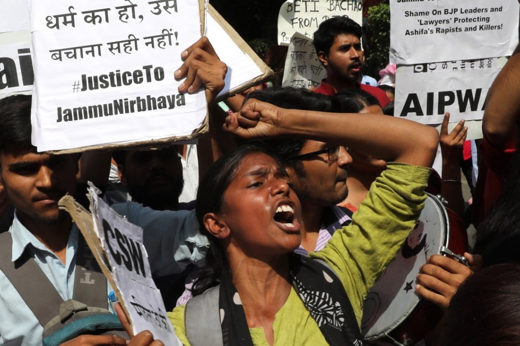 Indians hold placards that read in Hindi ‘Indian Government take stern action against the rapists’ as they protest against the alleged rapes Uttar Pradesh and Jammu and Kashmir. Photo: EPA