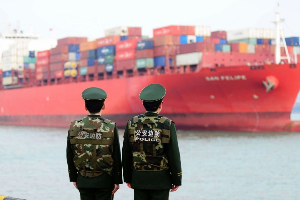 Chinese police officers watch a cargo ship at Qingdao in the eastern Shandong province. Should a full-scale trade war break out between the US and China, many countries would be forced to choose sides. Photo: AFP