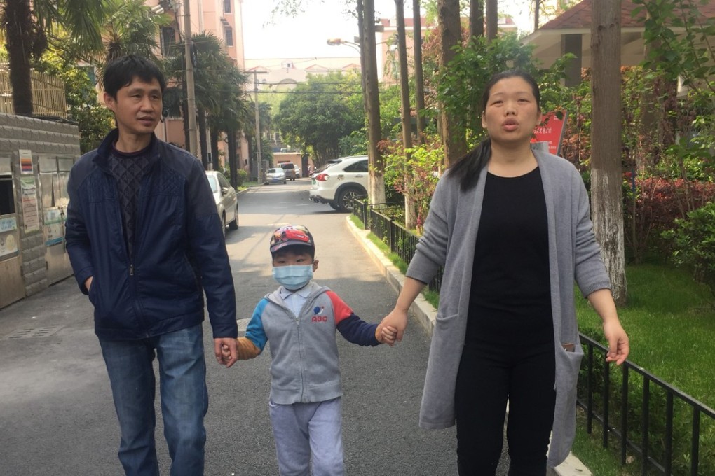 Five-year-old Gu Zisen takes a walk in Shanghai with his mother Fan Xiujuan and father Gu Xingping. Photo: Alice Yan