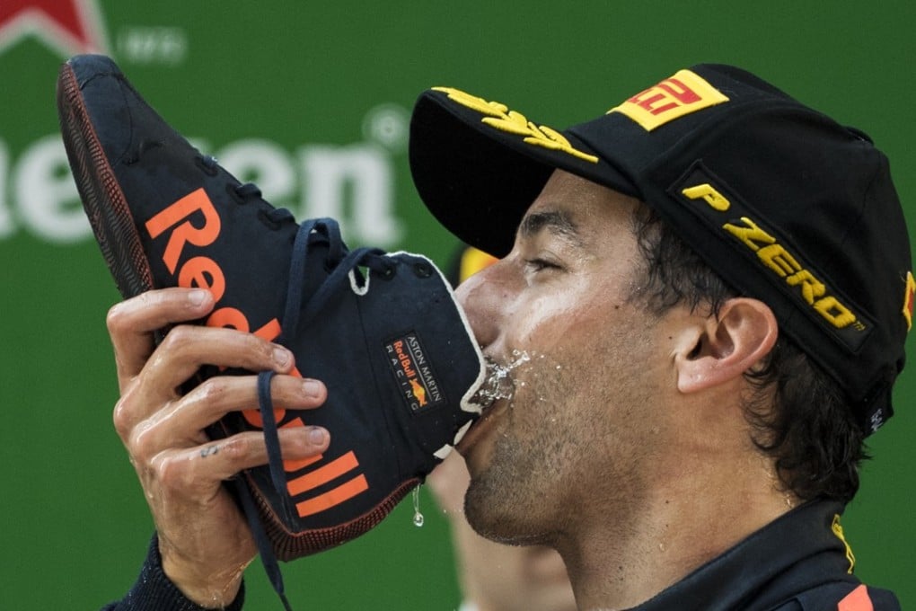 Red Bull's Australian driver Daniel Ricciardo drinks champagne out of his shoe as he celebrates on the podium after winning the Formula One Chinese Grand Prix in Shanghai. Photo: AFP