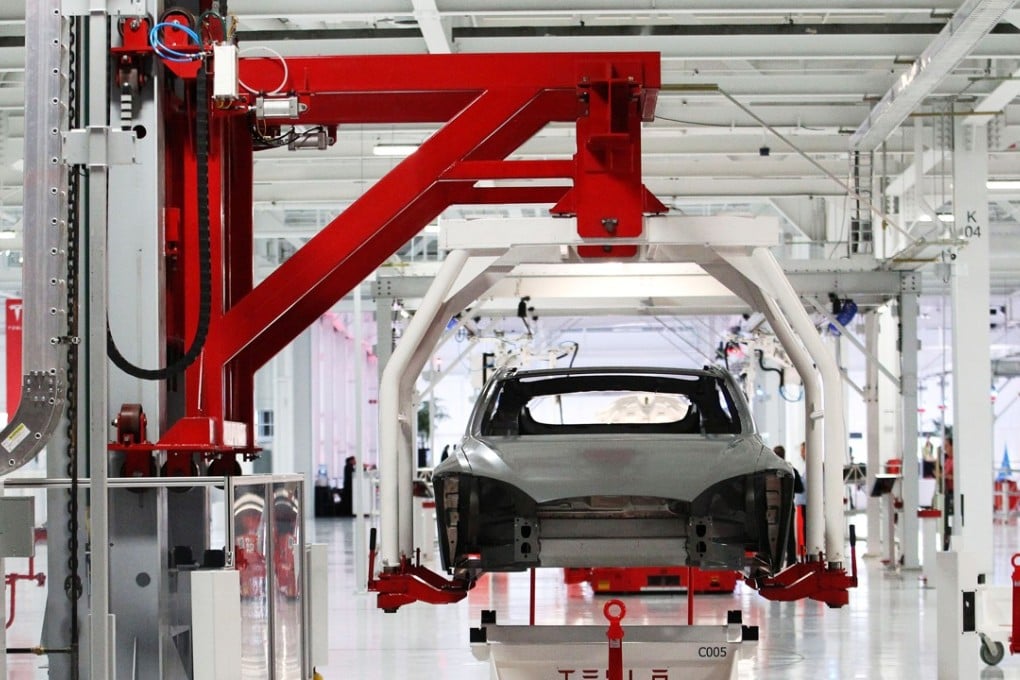 The body of a Tesla Model S is lifted by an automated crane at the Tesla factory in Fremont, California. Photo: REUTERS/Stephen Lam