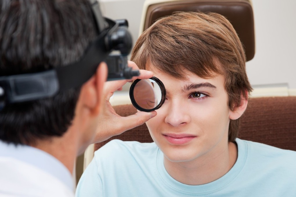 An optometrist performs a dilated retinal examination. Photo: Shutterstock
