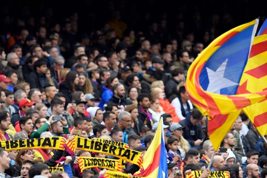 Barcelona fans hold up scarves demanding freedom during the match against Valencia CF at the Camp Nou. Photo: AFP