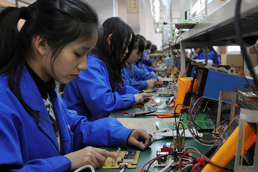 Workers assembling remote controls for air conditioners and water heaters at a factory in Hefei in Anhui province. Photo: Reuters