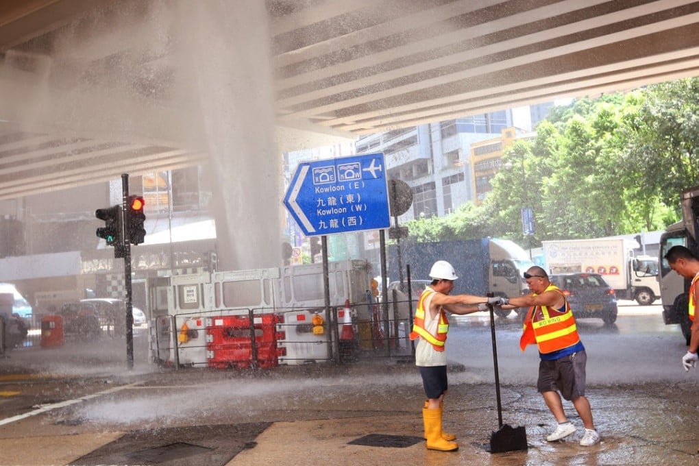Water Supplies Department workers repair a broken pipe at Canal Road West, in Causeway Bay. Photo: SCMP