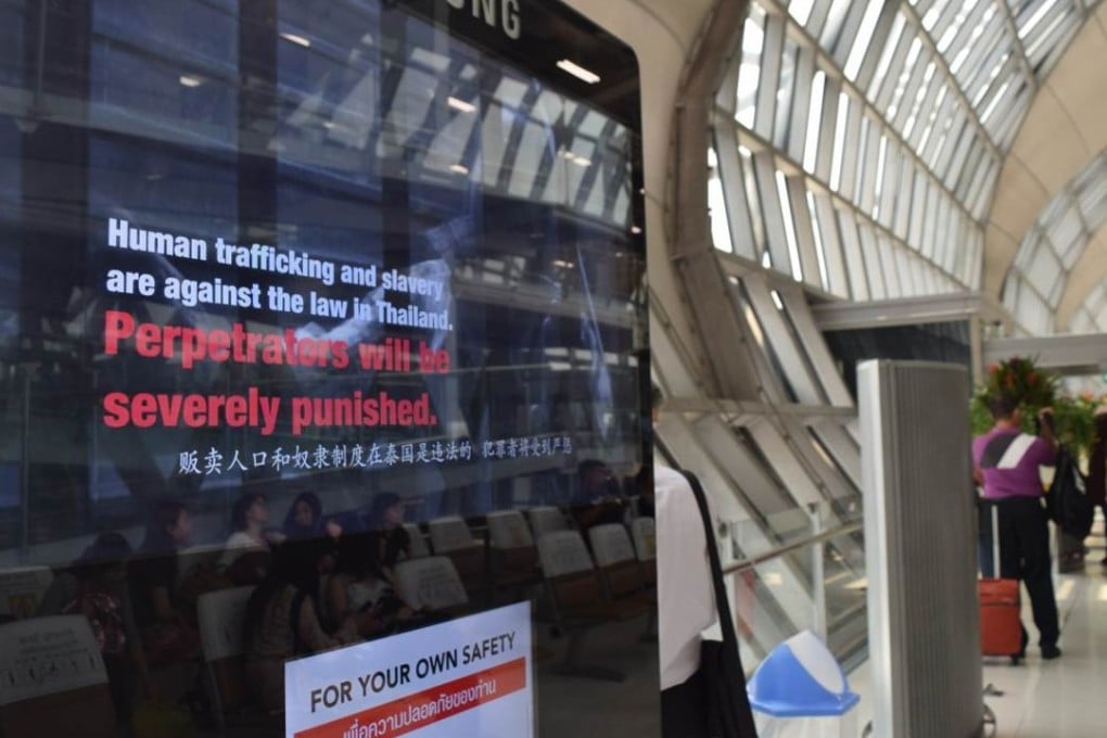 A television screen showing a message warning against human trafficking at Bangkok's main Suvarnabhumi Airport. Photo: Thomson Reuters Foundation